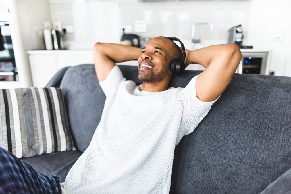 man listening music on the couch