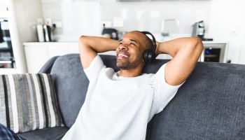 man listening music on the couch