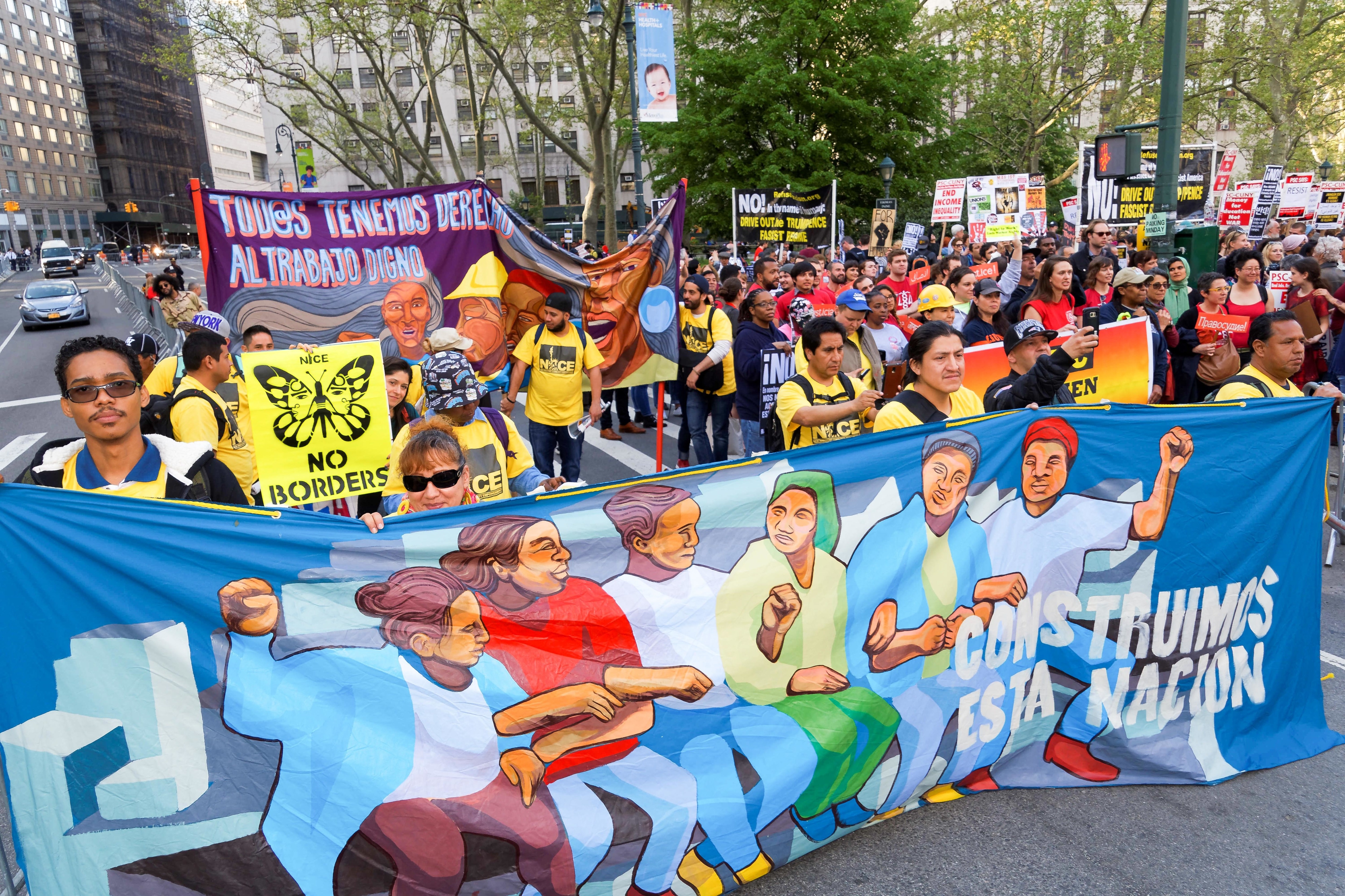 May Day protesters hold signs in Foley Square, Manhattan.