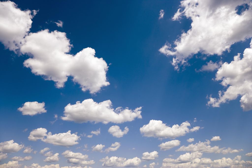 Fluffy white clouds in a blue sky