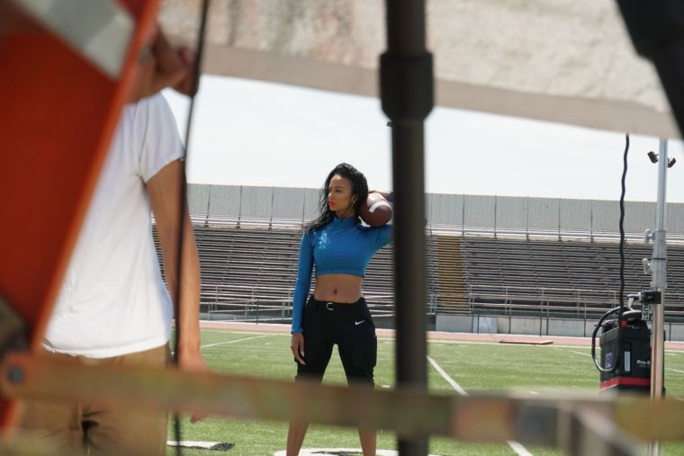 Rocking her own Mint Swim top, Nike football pants and Ferragamo booties, Draya combines high end with sports gear.