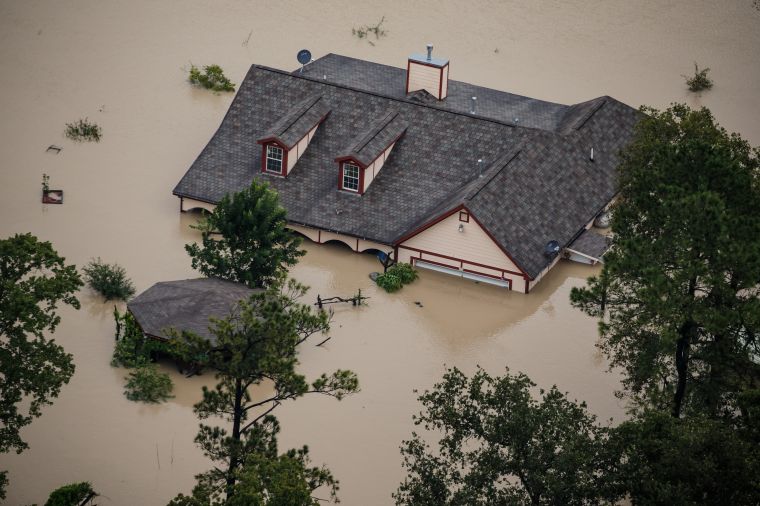 A house is completely submerged in flood water.