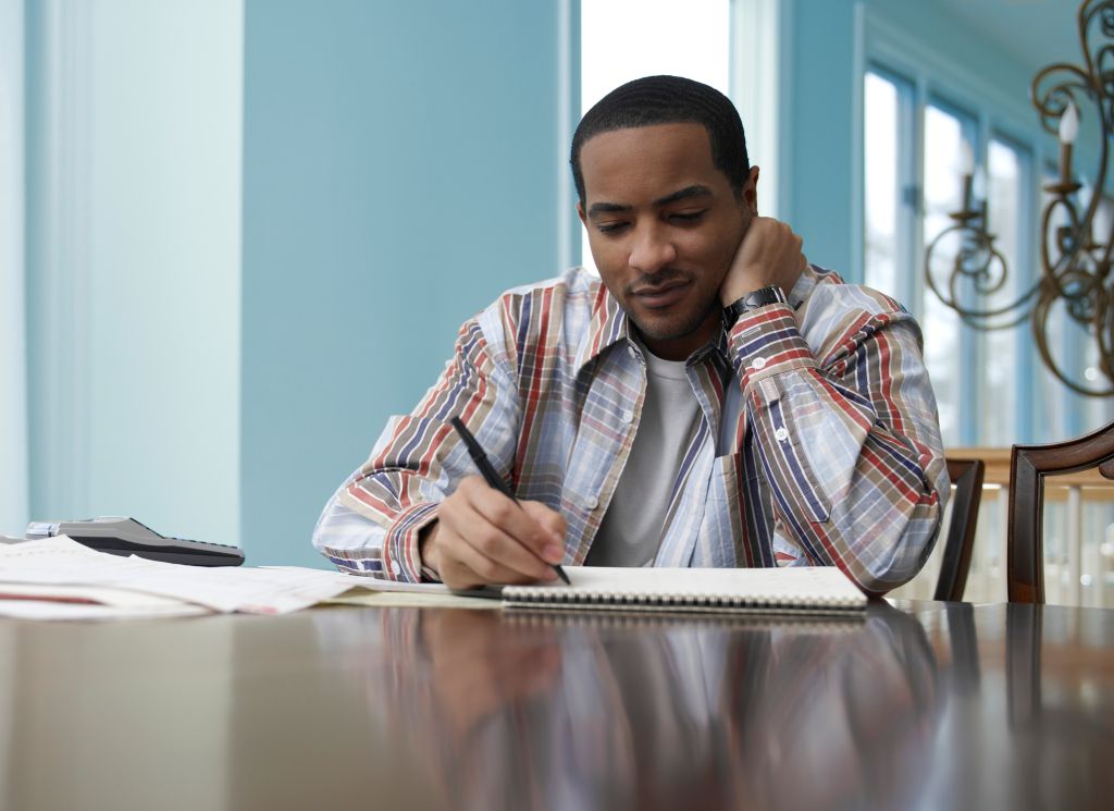 Man Calculating His Bills at Home