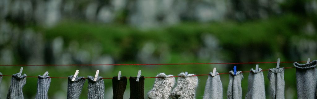 Several pairs of socks hang outside to dry on a clothes line, Faeroe Islands, Europe.