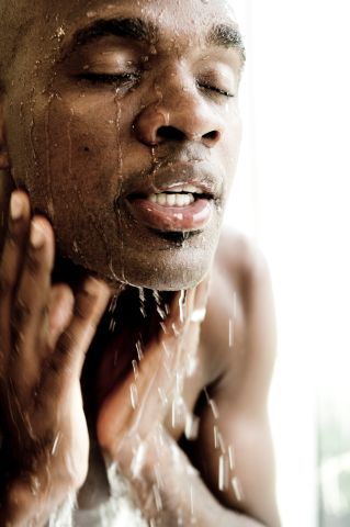 Young man washing his face