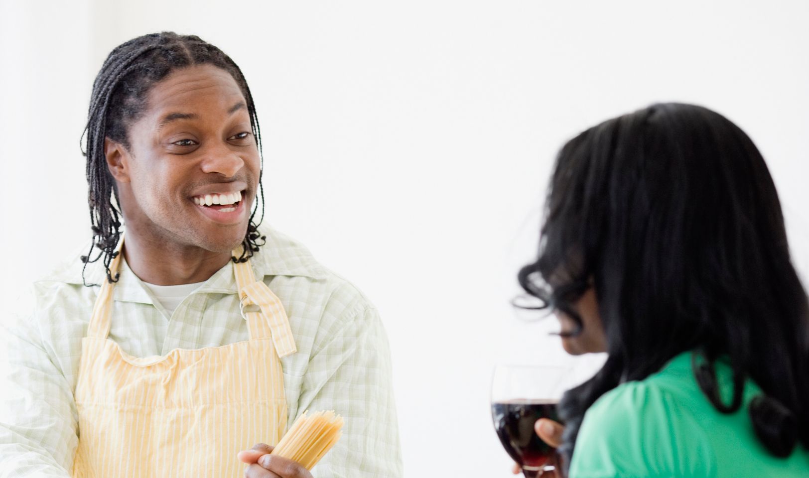African couple cooking in kitchen