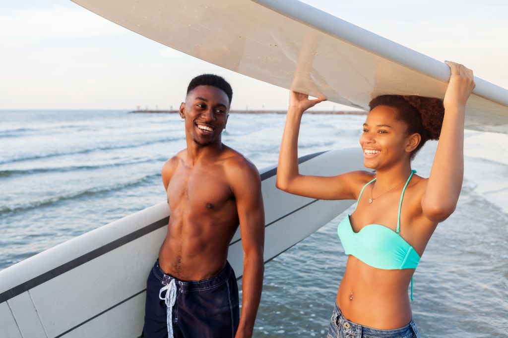 Friends prepare to surf together