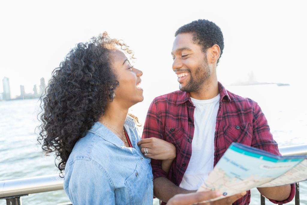 Cheerful young couple plans New York City vacation