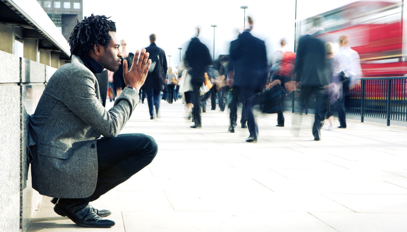 Contemplation from a solitary character contrasting against a hurried world