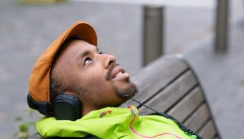 Man sitting outside, listening to music