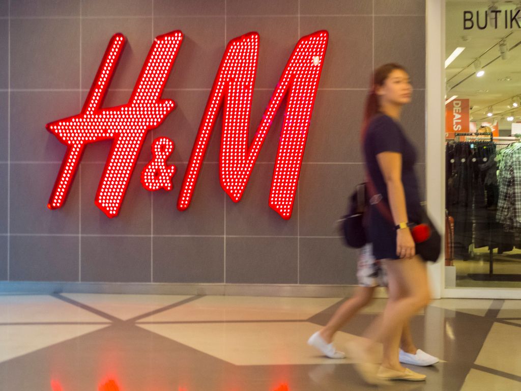 A woman seen walking in front of the H&M shop. Malaysia...