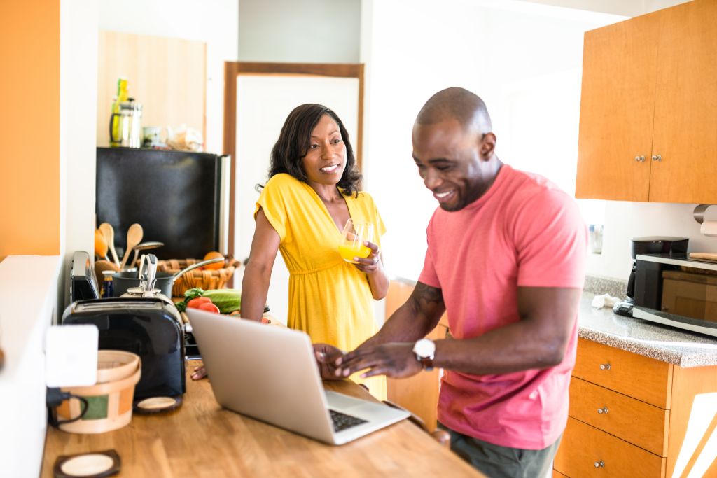 african family doing the breakfast on the pc
