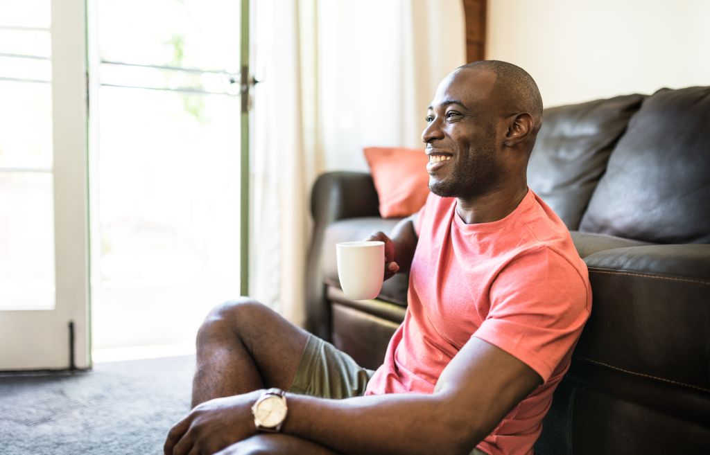 man realxing drinking the coffee on living room