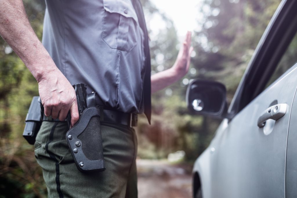 Police Officer With Hand on Weapon