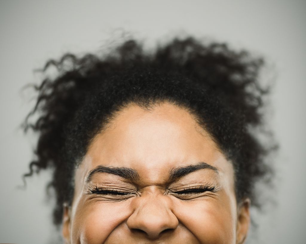 Excited happy afro american woman against gray background