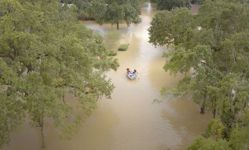 Rescue boat approaches, flooded street, Hurricane Harvey