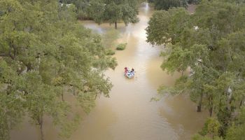 Rescue boat approaches, flooded street, Hurricane Harvey