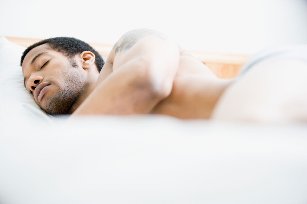 African American man sleeping in bed