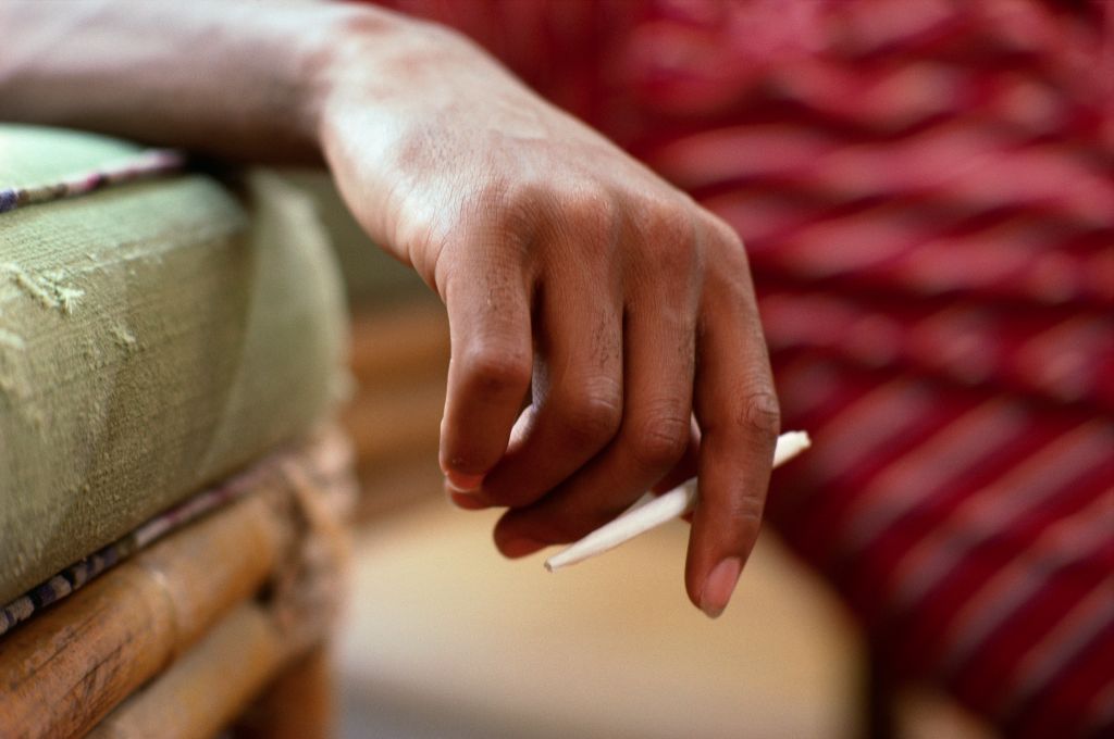 Person Holding a Marijuana Cigarette