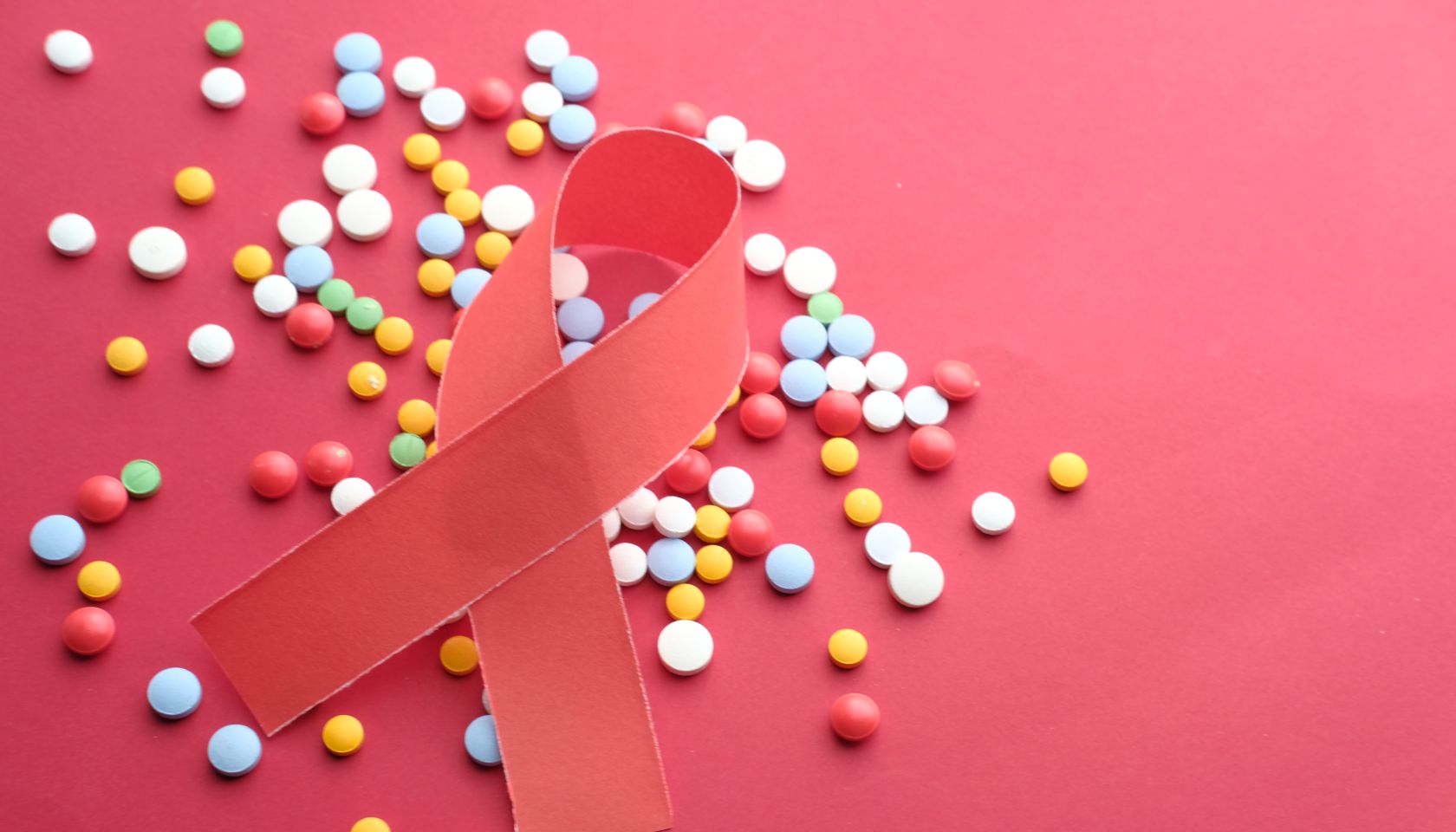 Red Ribbon and Medicins - AIDS awareness symbol on the red background.