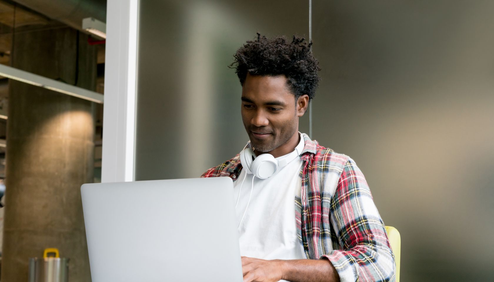 Happy man working online at a co-working office