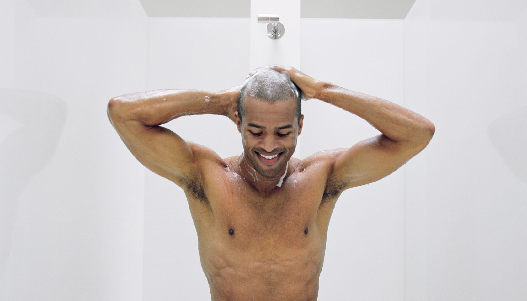 Man washing hair in shower