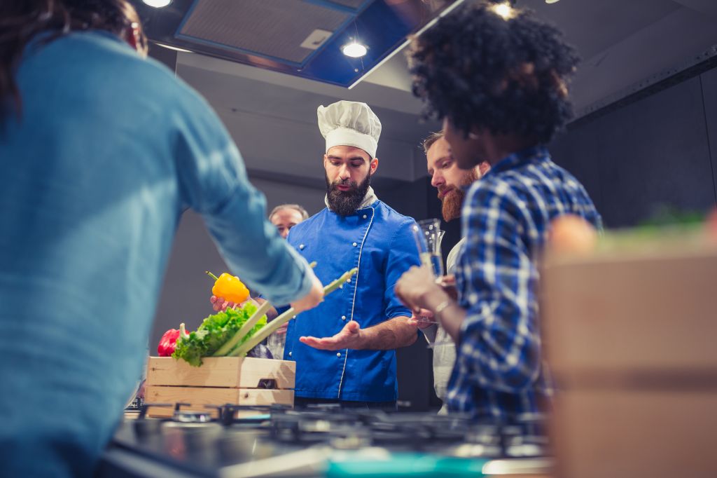 Young chef welcoming his cooking class