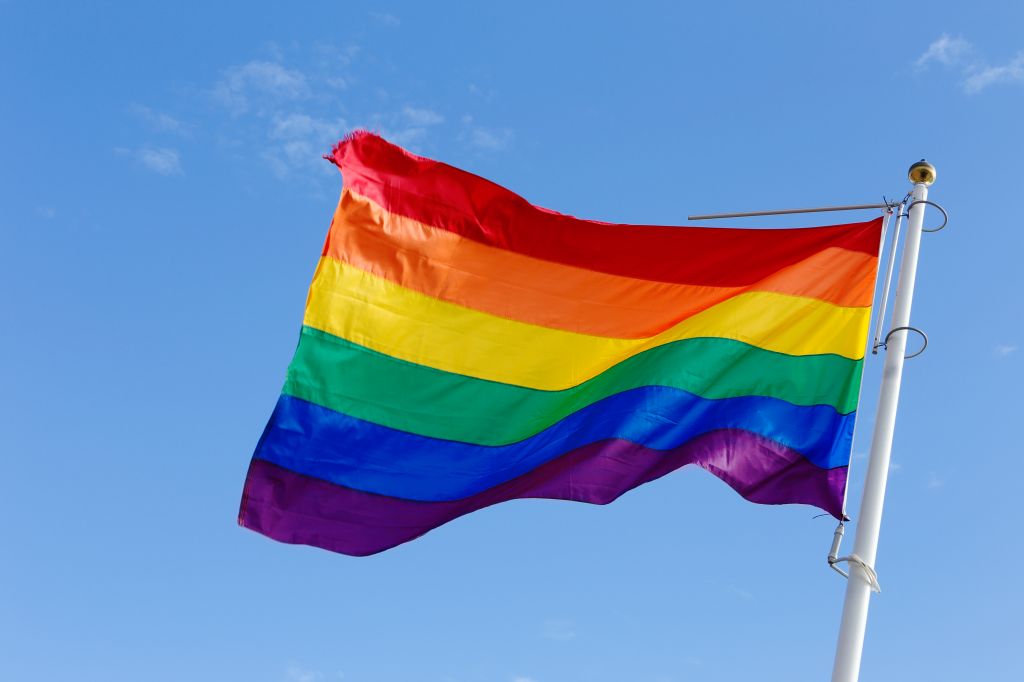 Low Angle View Of Rainbow Flags Against Sky