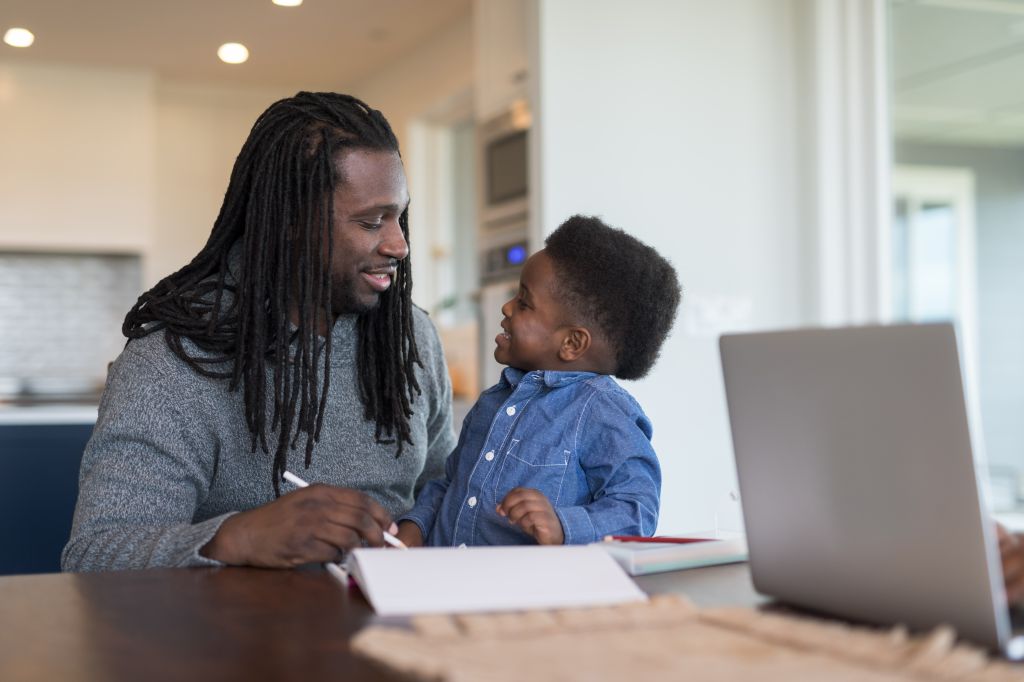 African American family works together at the dining room table