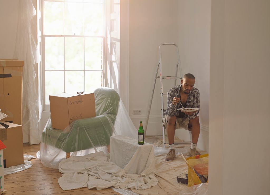 Man taking a break from doing DIY in his new home