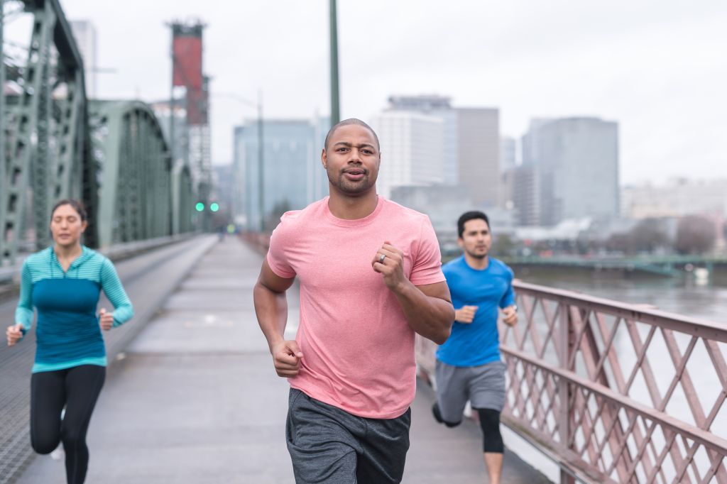 A group of co-ed runners goes for a training run in the city