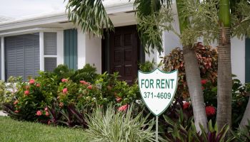 A for rent sign outside a house at Jupiter Inlet Colony.
