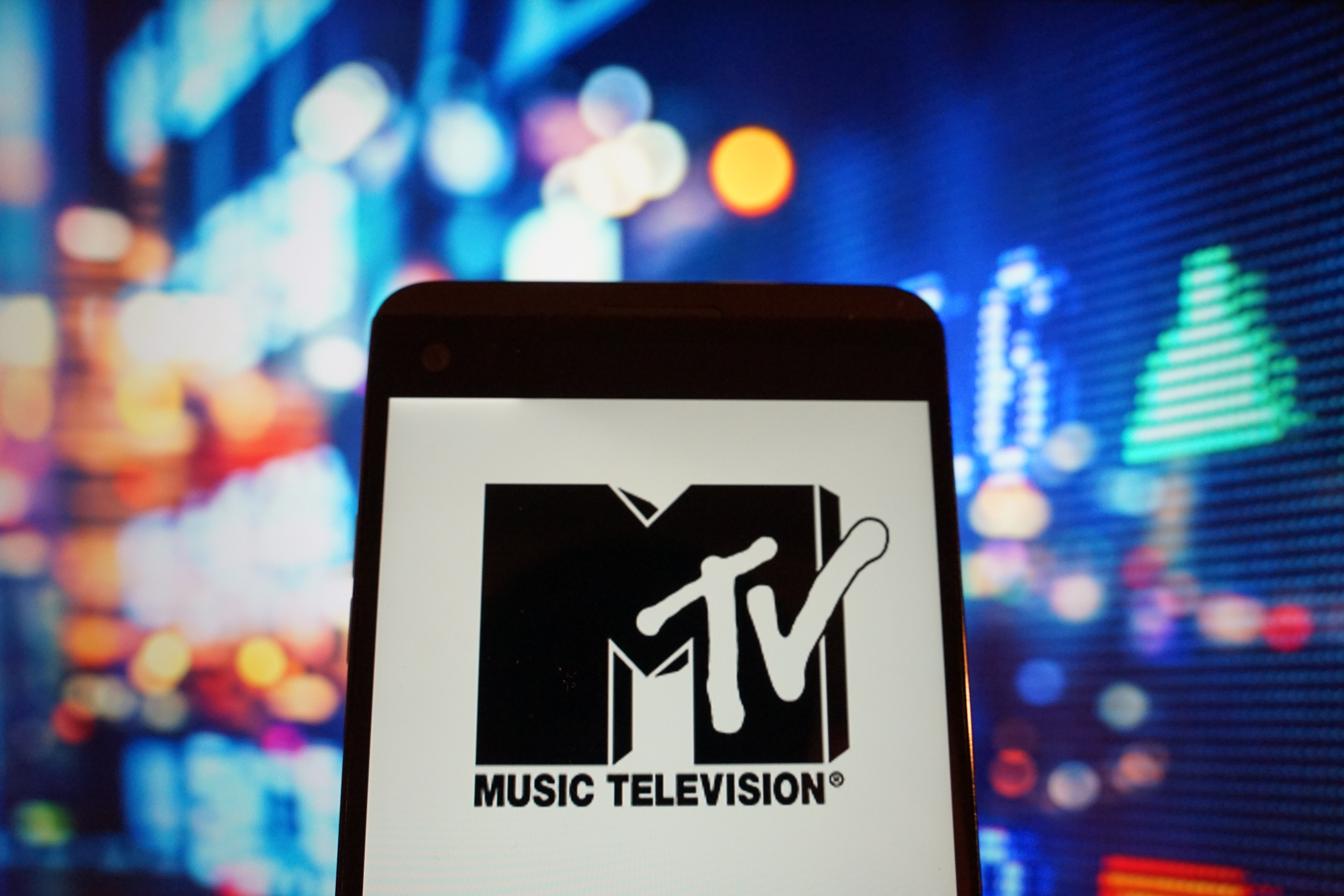The logo of music television is seen in a smartphone...