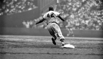 Dodger Jackie Robinson rounds first during a game against the Giants.