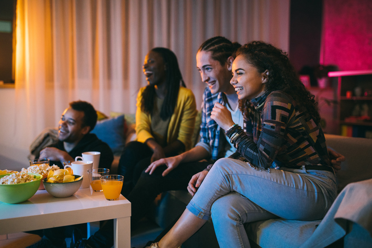 Friends watching comedy movie at home