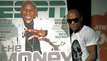 Floyd Mayweather poses with a copy of ES