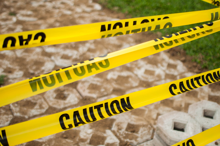Yellow tape caution sign outdoor during day time
