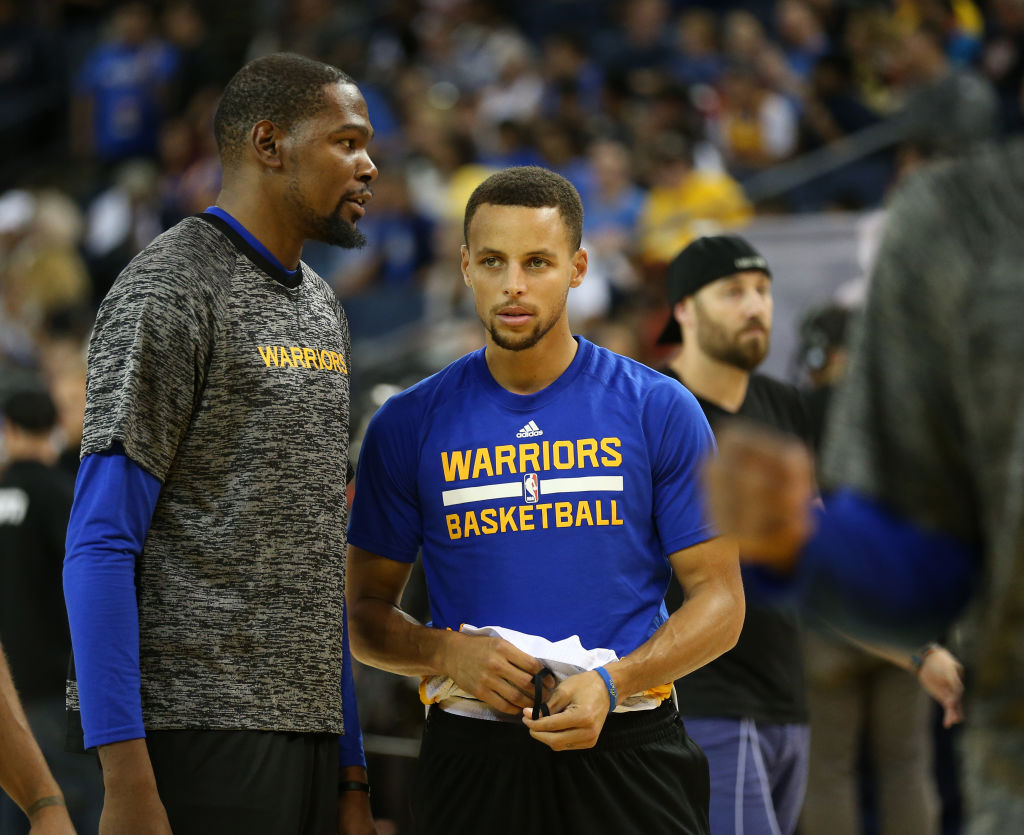 Golden State Warriors' Kevin Durant (35) and Stephen Curry (30) talk as they warm up before their game against the Los Angeles Clippers at Oracle Arena in Oakland, Calif., on Tuesday, Oct. 4, 2016. (Jane Tyska/Bay Area News Group)