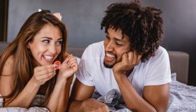 men and women are discussing the use of condoms. young couple in bed