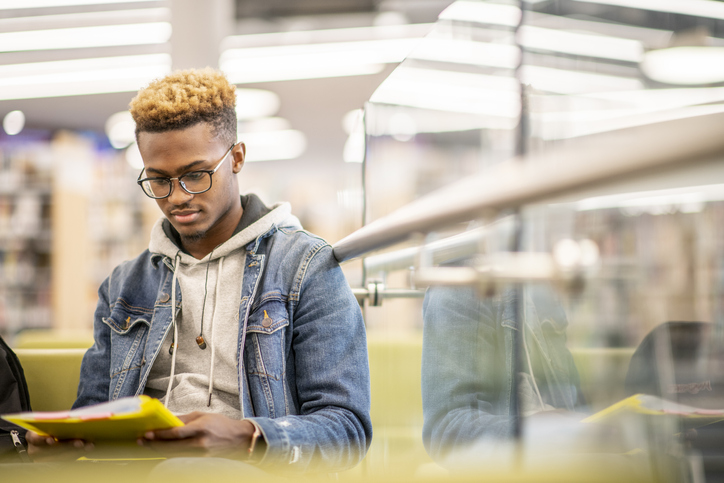 An African American University Student Studying in the Library stock photo