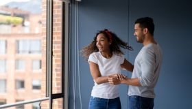 Excited couple looking very happy at their new house