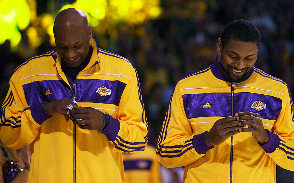 Lamar Odom (left) and Ron Artest look at their championship rings before the start of the Laker ope