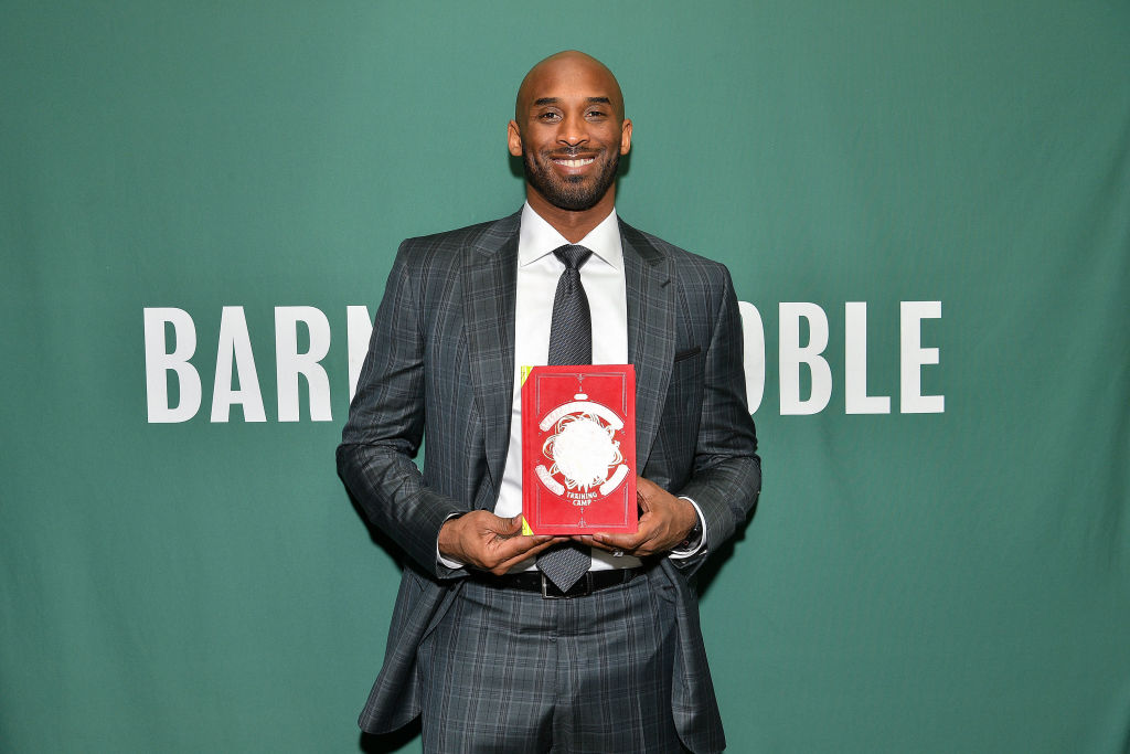 Kobe Bryant Signs Copies Of His Book "Training Camp (The Wizenard Series #1)"
