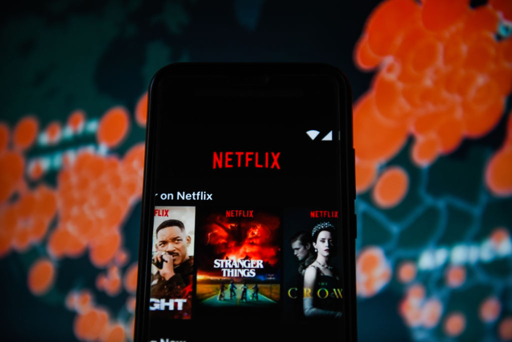 In this photo illustration a Netflix logo is seen displayed...