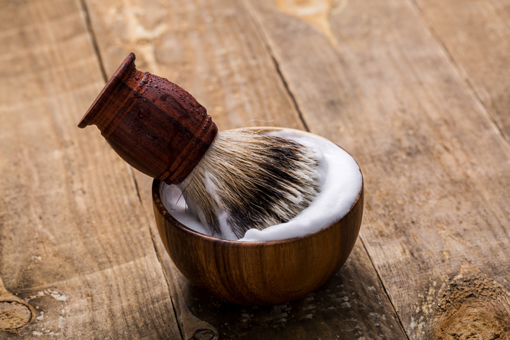 Shaving brush and bowl on table. Shaving accessories