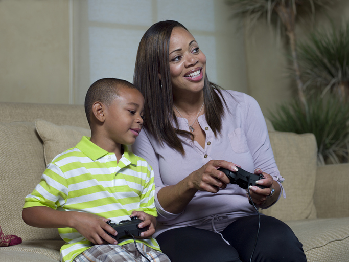 Mother and son playing video games