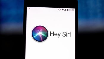 In this photo illustration the Siri logo is displayed on a...
