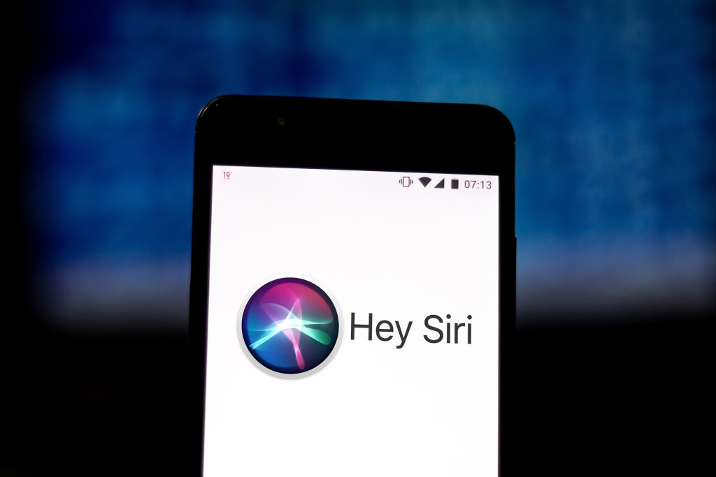 In this photo illustration the Siri logo is displayed on a...