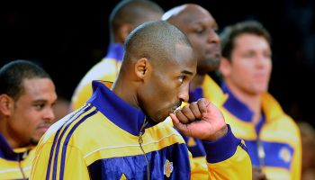 Lakers Kobe Bryant kisses his championship ring during a ceremony at the Staples Center Tuesday.