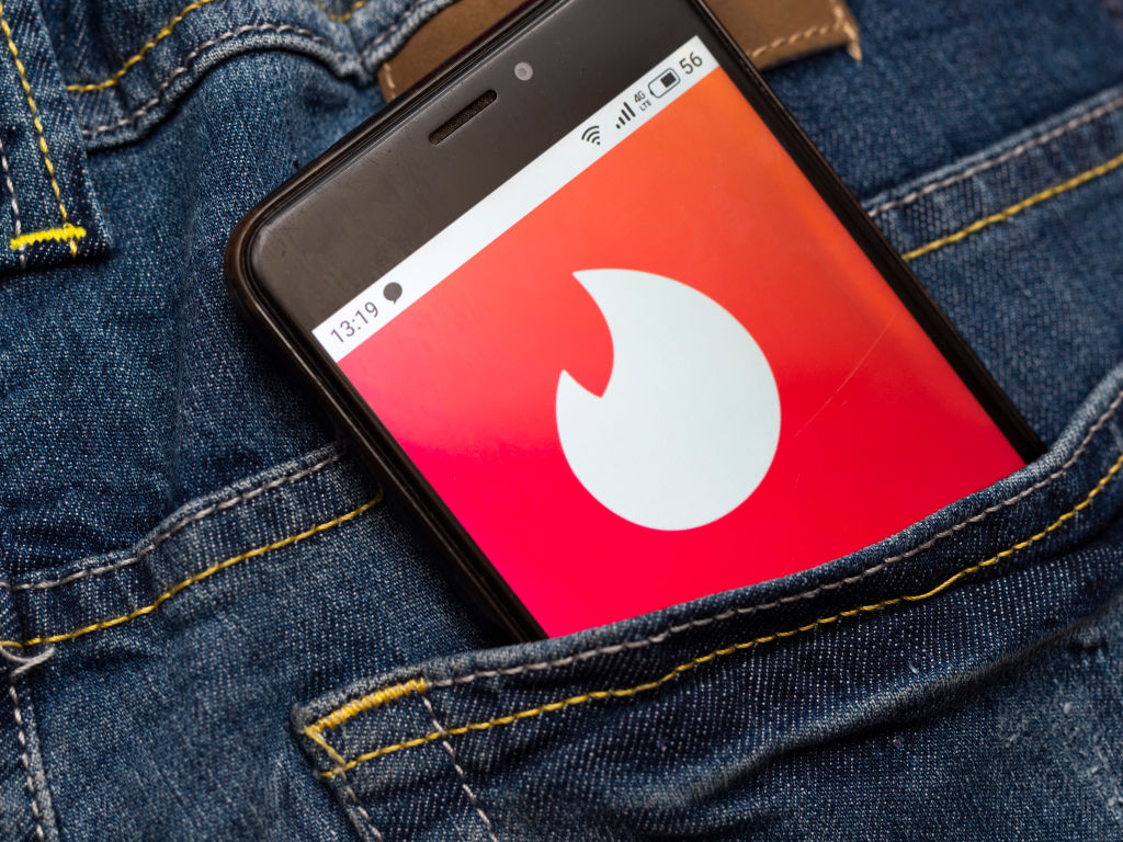 In this photo illustration a Tinder social network logo seen...